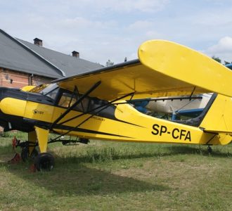 podwórze i żółty samolot do agrolotnictwa